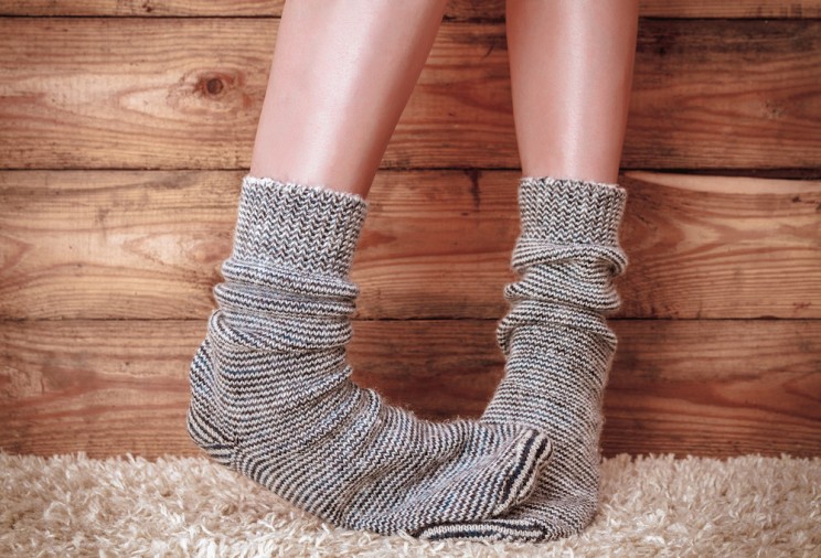 close up of woman's feet in grey and black stripe socks