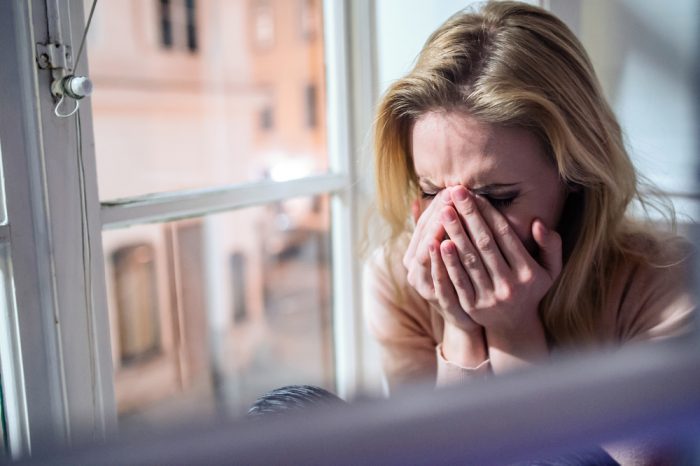 woman crying into her hands people crying