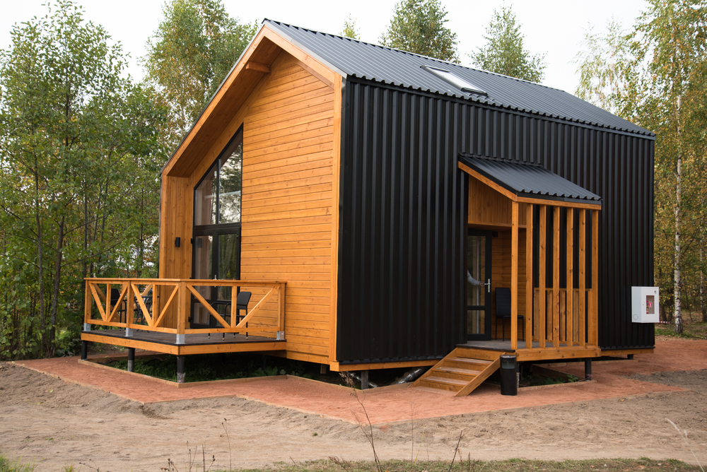 Barnhouse style house. House in the bosom of nature. Greenery and trees.