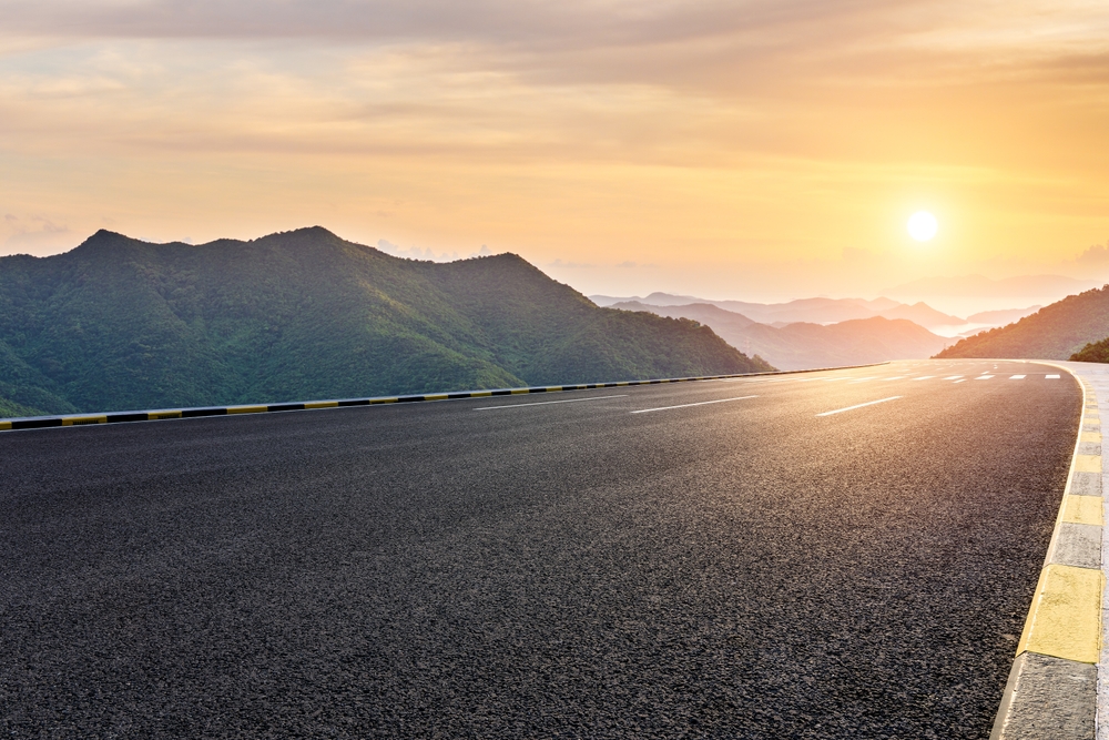 Asphalt highway road and mountain with sky clouds at sunset
