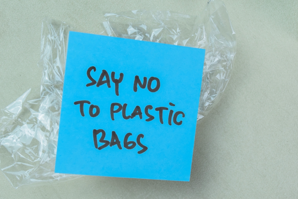 Concept of Say No To Plastic write on book isolated on Wooden Table.