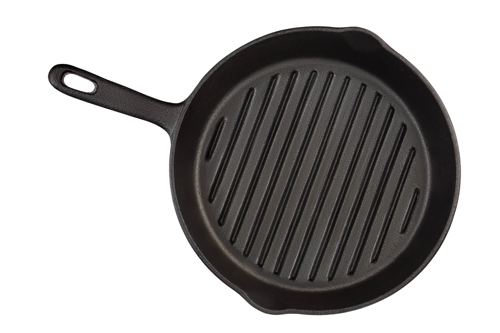 Empty cast iron grill frying pan isolated on white background with clipping path. Top view.