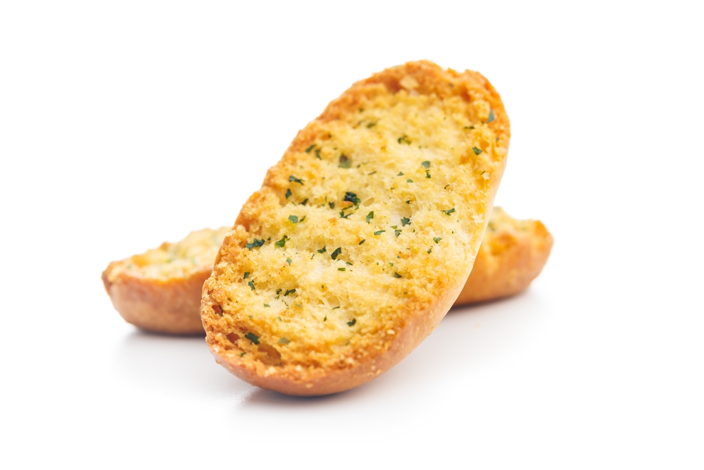 Garlic crisp bread Slices Topped With Herbs isolated on a white background.