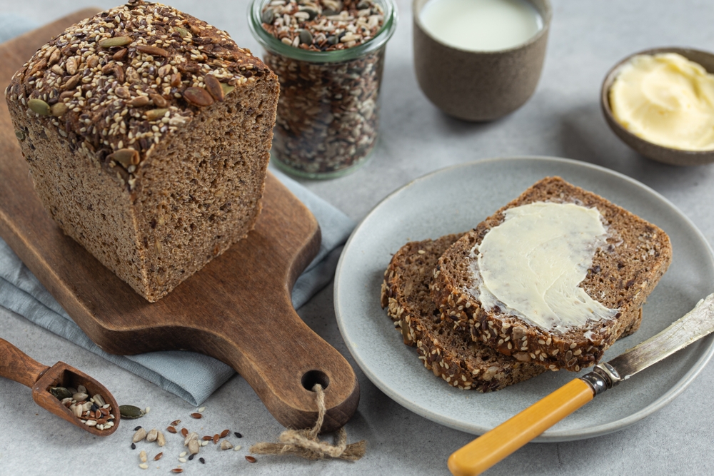 freshly baked homemade seeded multigrain sour dough bread with butter