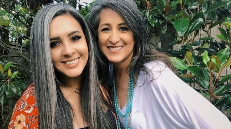 With her natural gray hair and undeniable grace, she embodies the timeless beauty and strength her mother passed down to her. 