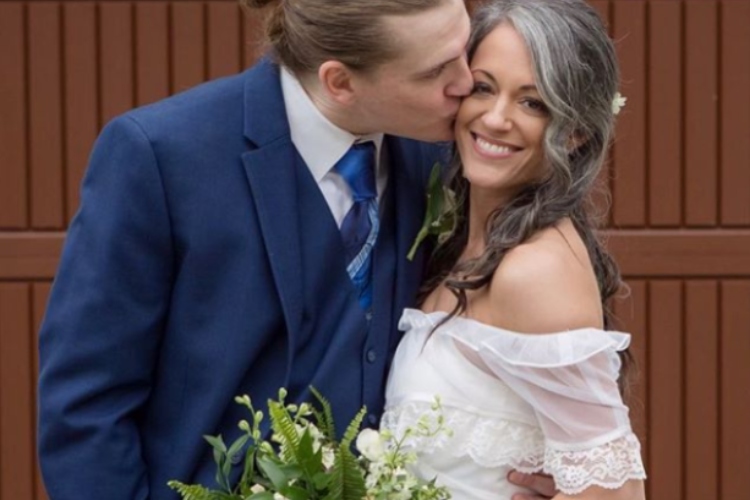 Formally dressed man in a blue suit and a woman in a white dress