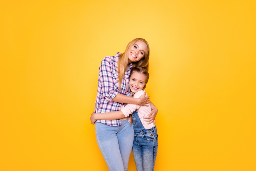 Different age cute niece feelings relatives youth generation concept. Portrait of sweet lovely joyful beautiful girl with pigtails denim outfit hugging pretty aunt isolated on bright vivid background
