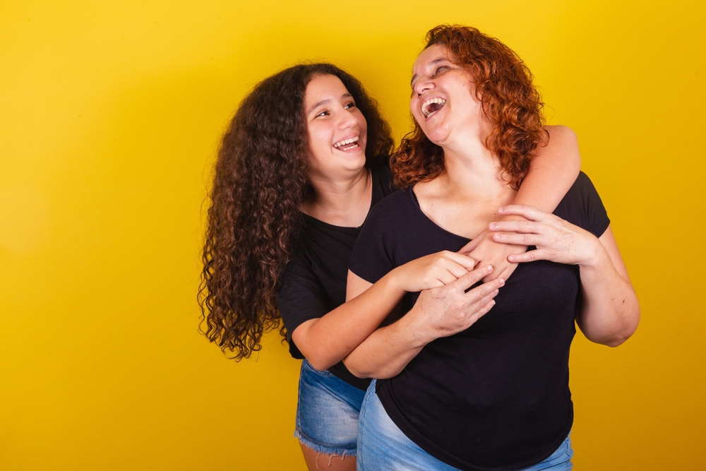 Grandmother and niece, Brazilian, Latin American, curls, afro hair, curly, smiling, hugging, family photo, beautiful. Mother's Day, Fraternity, Love.