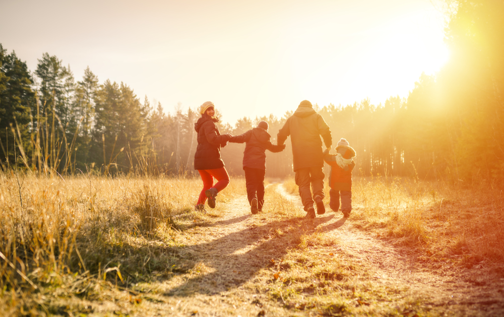 family running on country road in autumn time
