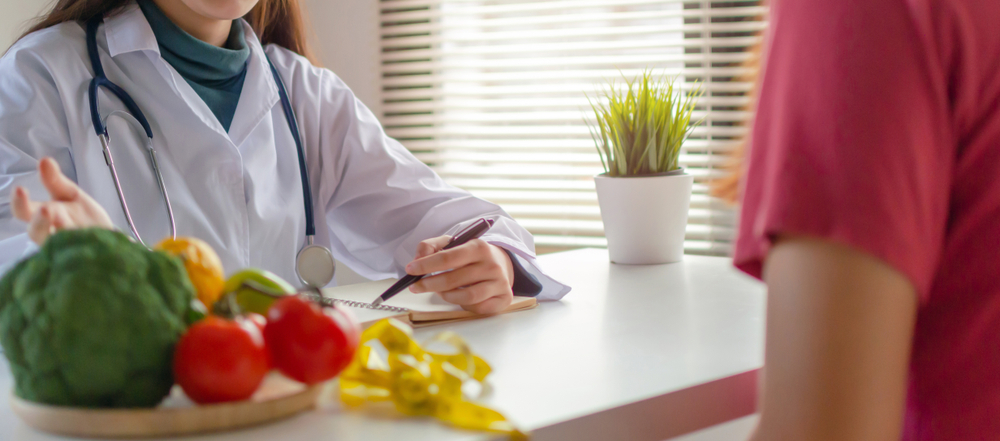 Panoramic banner. Nutritional. friendly nutritionist female doctor medical talking about diet plan with vegetable to young patient in office hospital, nutrition, food science, healthy food concept