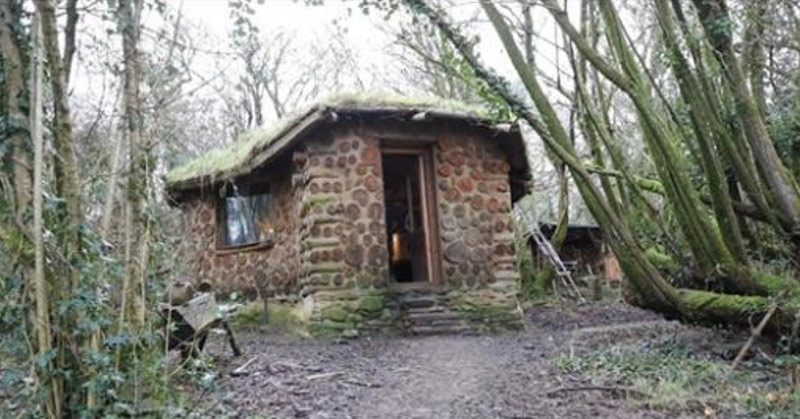 Man shows the inside of his tiny home in the woods