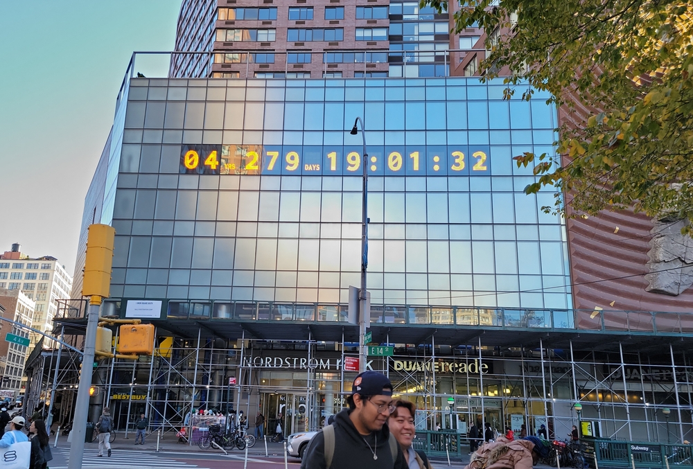 New York, NY, USA - 10-15-2024: Metronome, the Climate Clock, installed at 1 Union Square South on 14th Street building ten stories high. The NY clock that told time before, now tells the time remai
