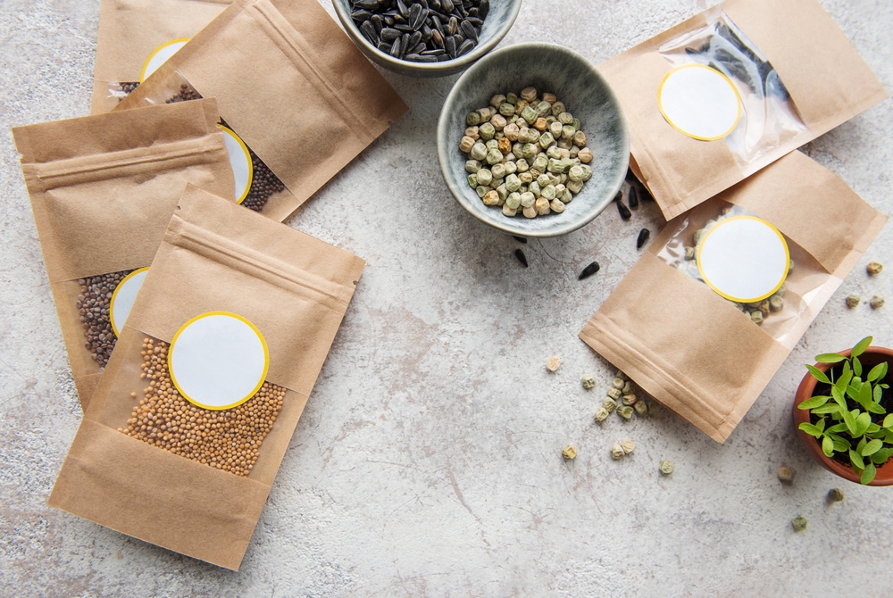 Microgreen seeds in paper bags and microgreen sowing equipment on the table. Healthy food.