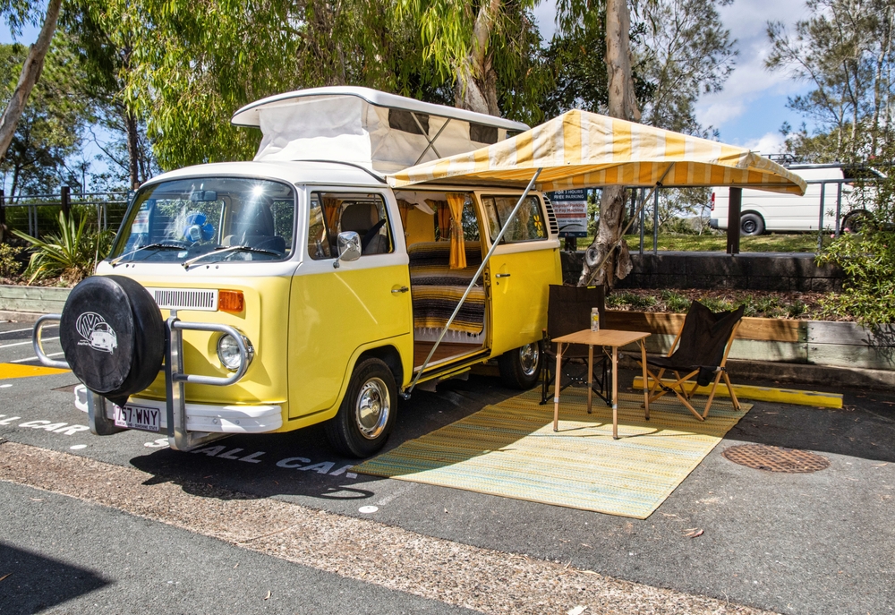 NOOSA, AU - Feb 18, 2023: Yellow VW Kombi Campervan with awning