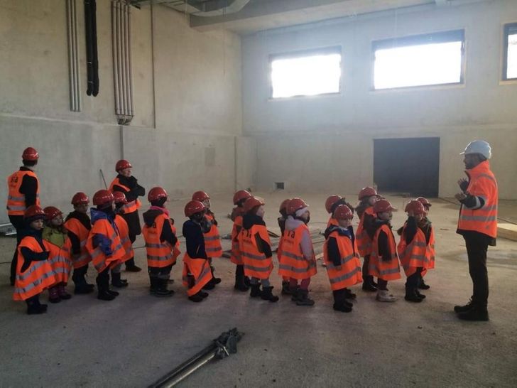 A group of kids in Hi-Viz vests