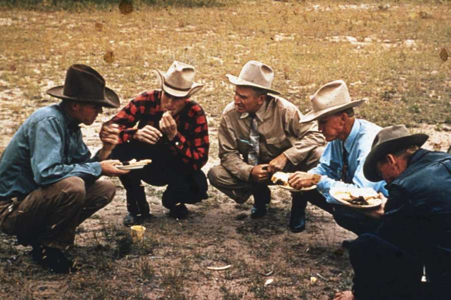 Men eating at a barbeque together