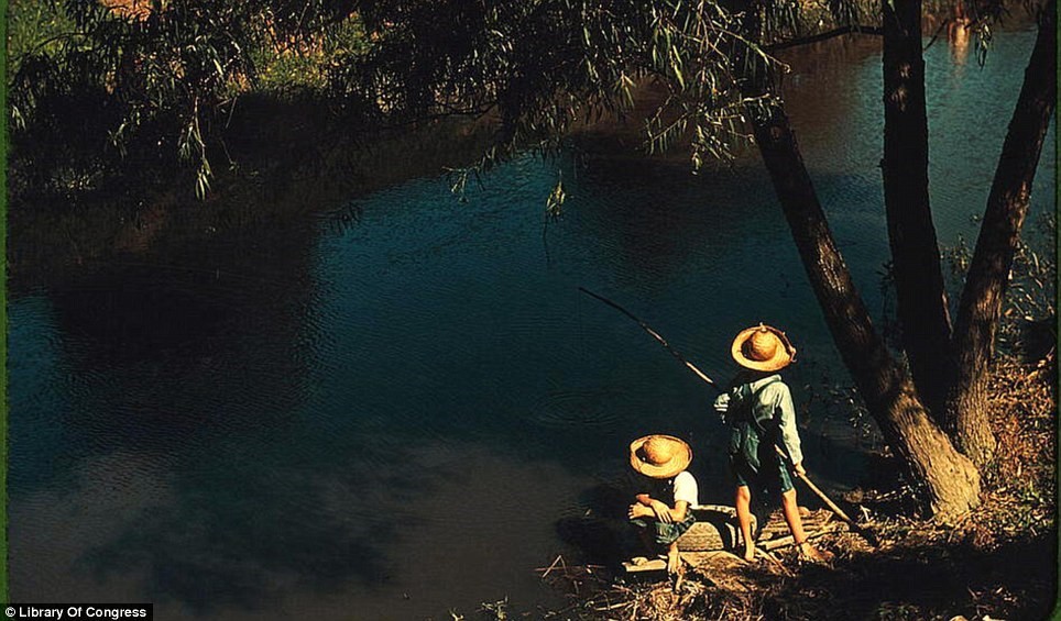 June 1940: Two boys fishing in a bayou in Schriever, Louisiana