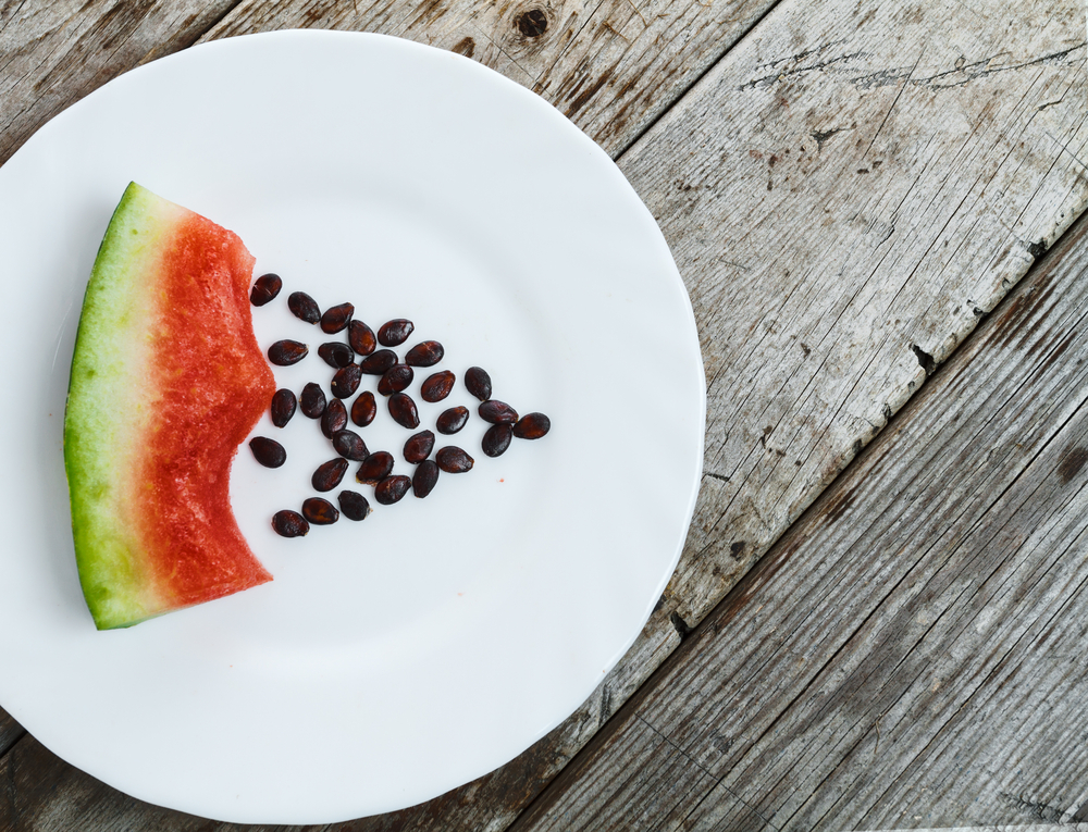 Eaten watermelon on a plate with pits
