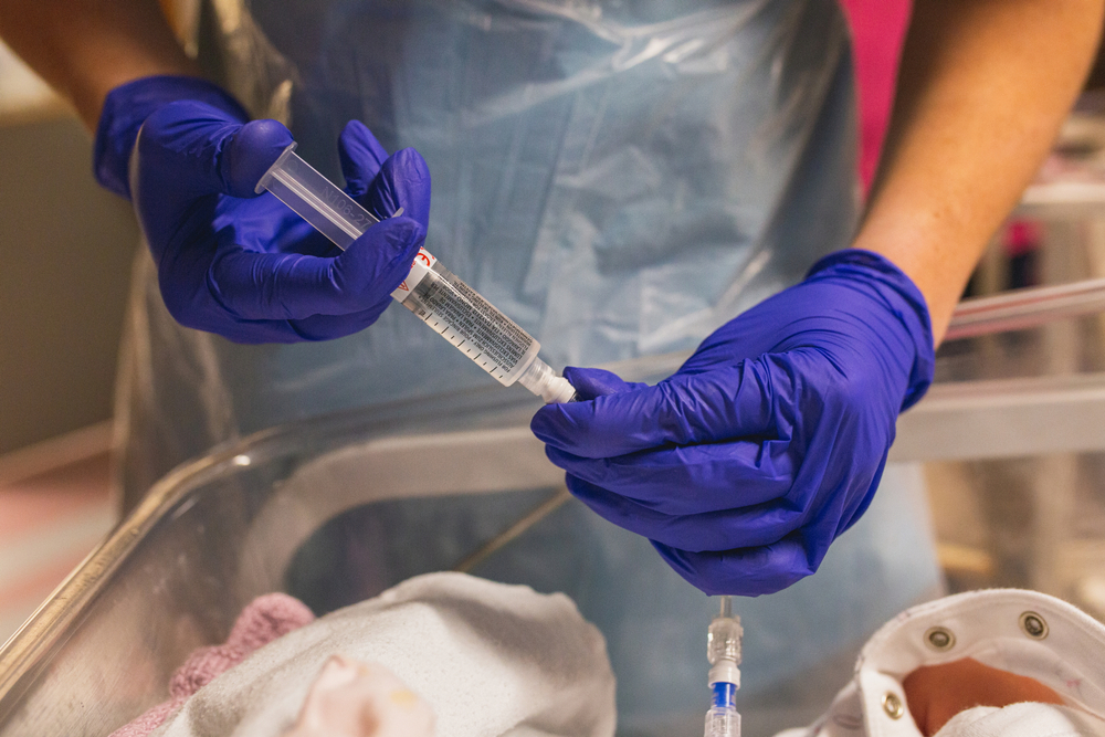 Coronavirus and small baby being born. Covid-19 giving birth during isolation. Covid pandemic flue and giving birth. Vaccinations and antibiotics for newborn. Doctor checking newborn baby. Sepsis.