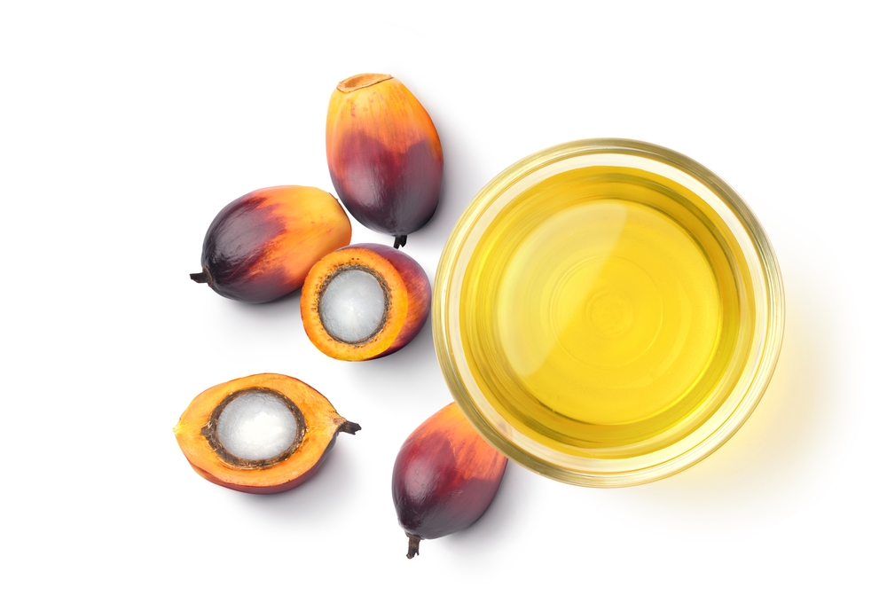 Top view of Palm oil with palm nuts isolated on white background.

