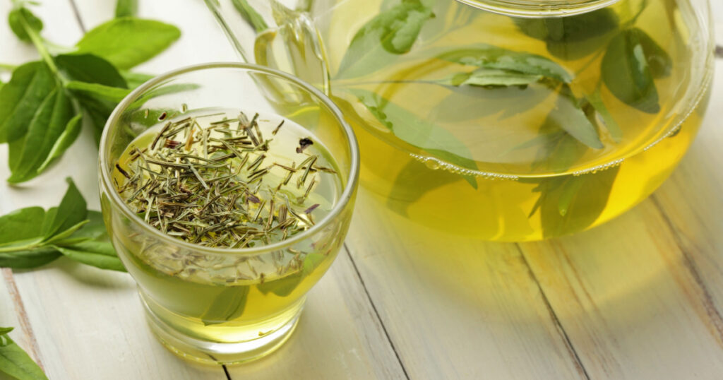 healthy green tea cup with tea leaves