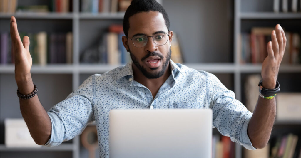 confused unhappy businessman looking at screen