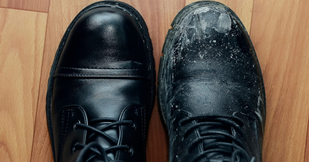A clean shoe stands next to a dirty one.