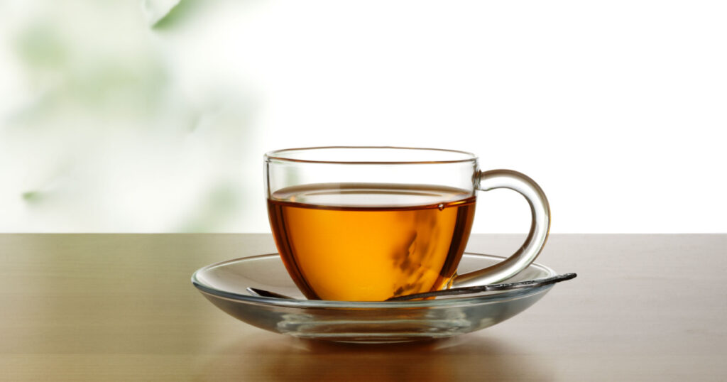 A cup of broadleaf plantain tea on the table