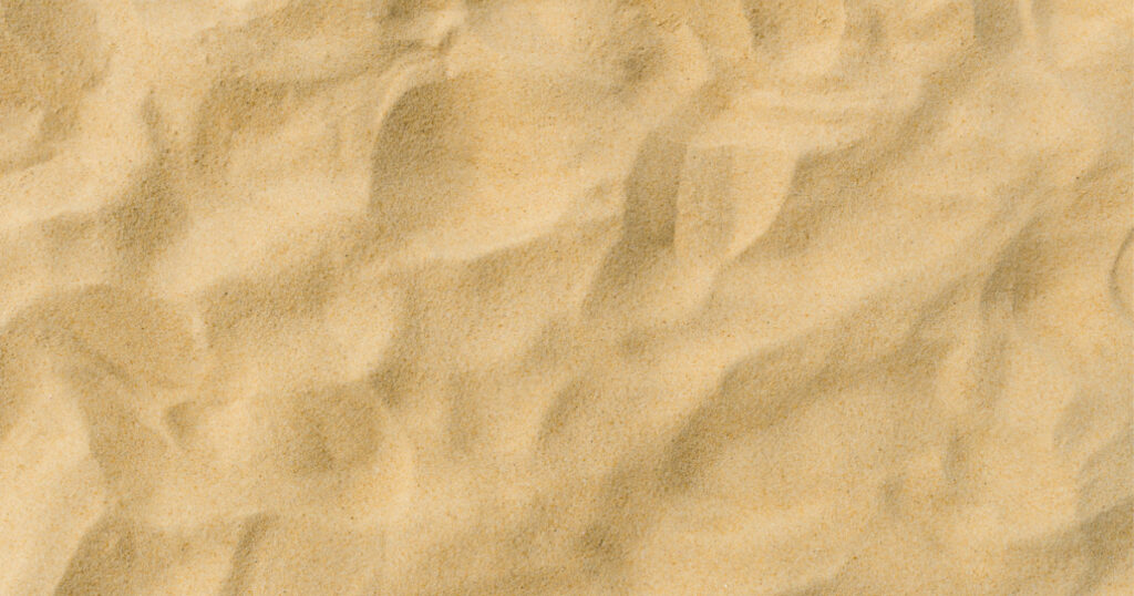closeup of sand pattern of a beach in the summer
