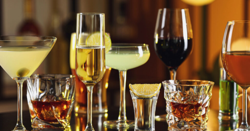 Different alcohol drinks on table in bar