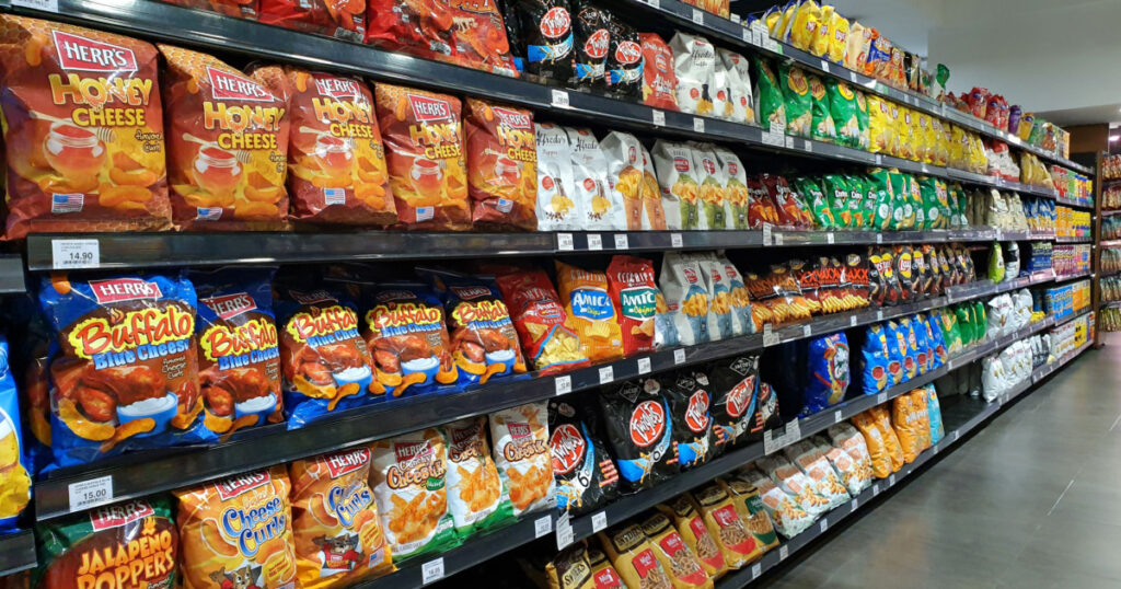 PENANG, MALAYSIA - 8 MAR 2021: Various local and imported brand of flavoured chips and snacks on store shelf in Mercato grocery store. Mercato is the coolest fresh premium supermarket in Malaysia.