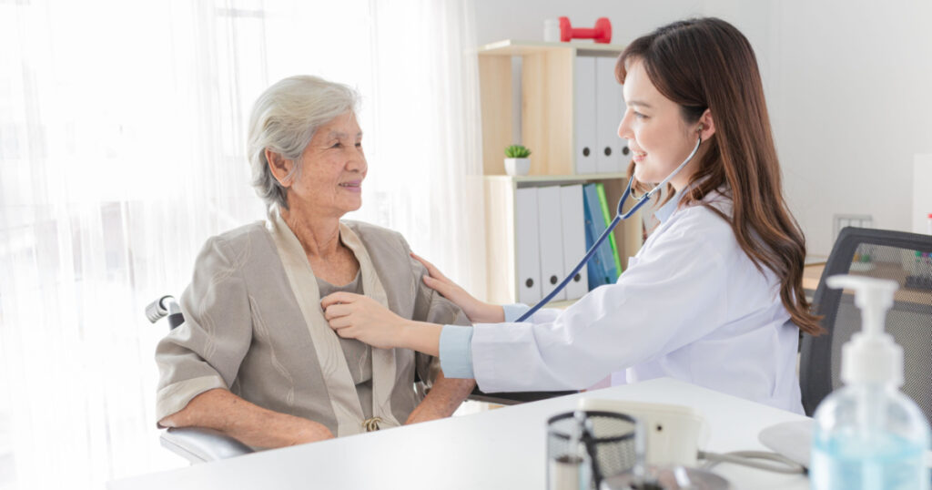 close up doctor, Asian doctor talk with old female patient about disease symptom, doctor use stethoscope listening lung of patient, elderly health check up, happiness hospital
