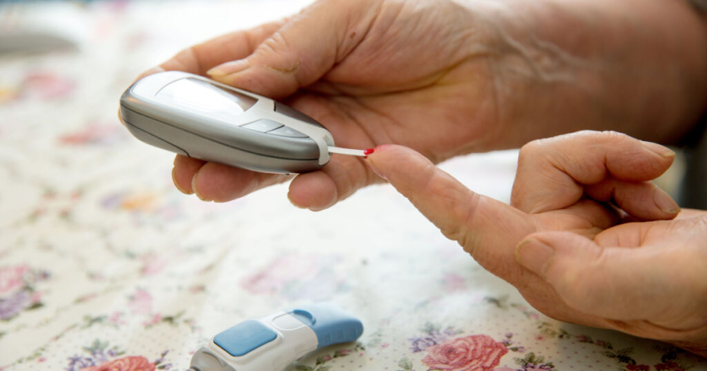 Senior woman is checking her sugar level with glucometer. In 2013 it was estimated that over 382 million people throughout the world had diabetes.