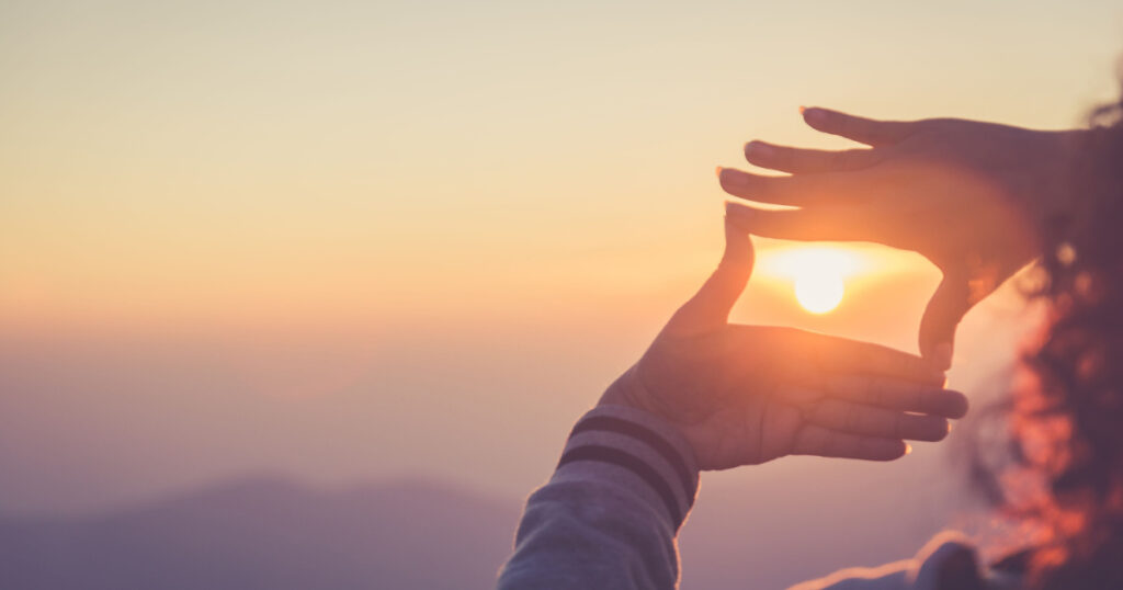 hands towards sunset