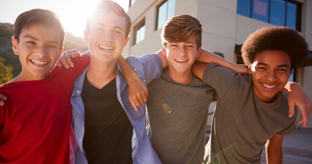 Portrait Of Male High School Student Friends Outside College Buildings