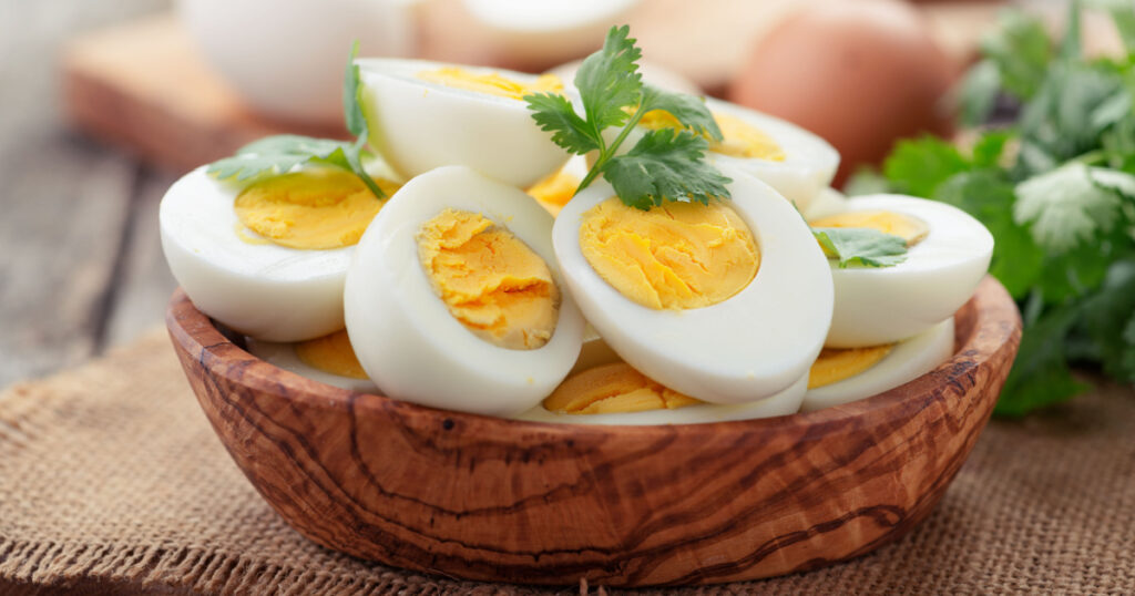 Sliced boiled eggs,decorated with parsley leaves.