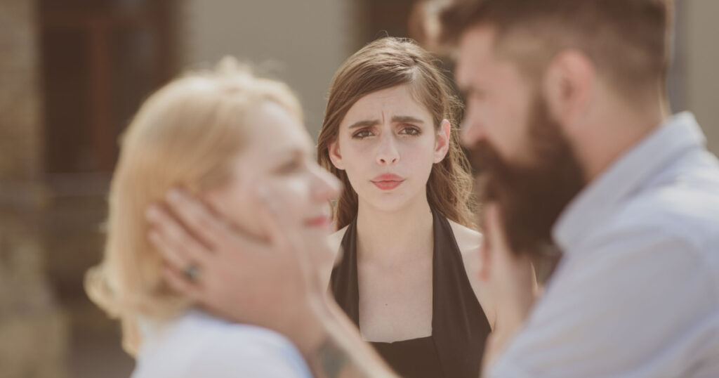 woman jealous and comparing herself to happy couple