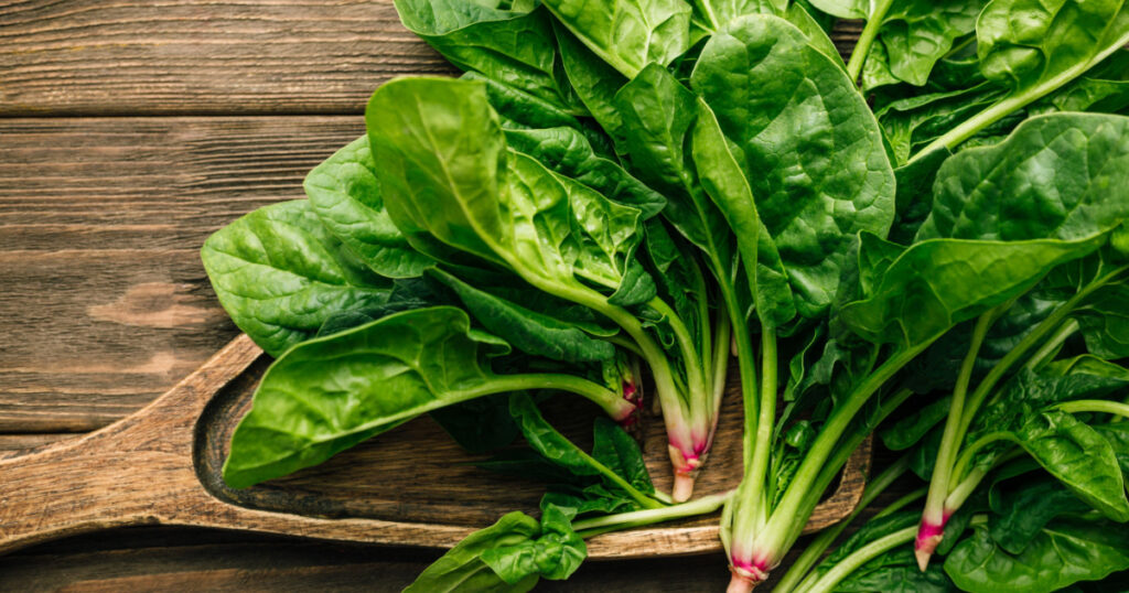 Fresh spinach on wooden background