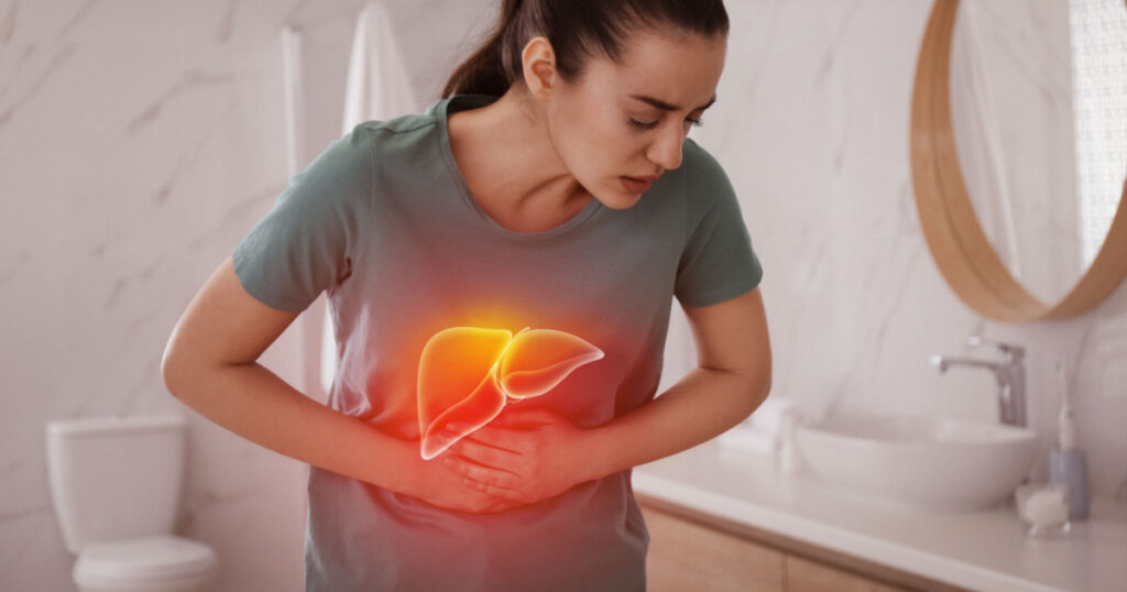 Sick woman suffering from pain in bathroom and illustration of unhealthy liver. Hepatitis disease
