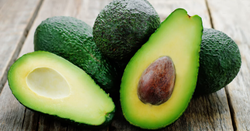 avocado on a dark wood background. tinting. selective focus