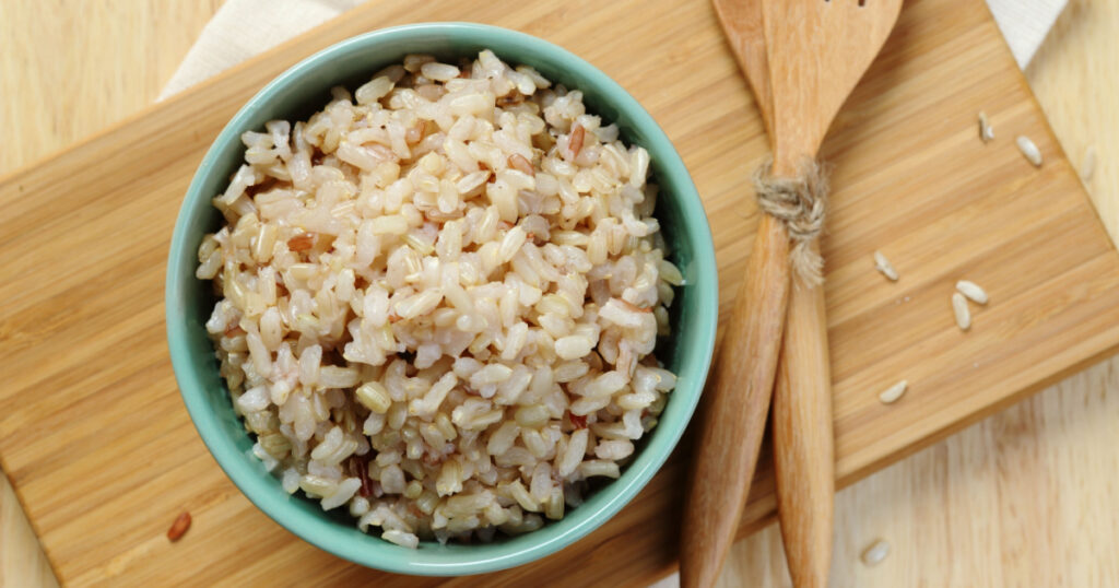 Organic Brown Rice in the bowl on the wooden table