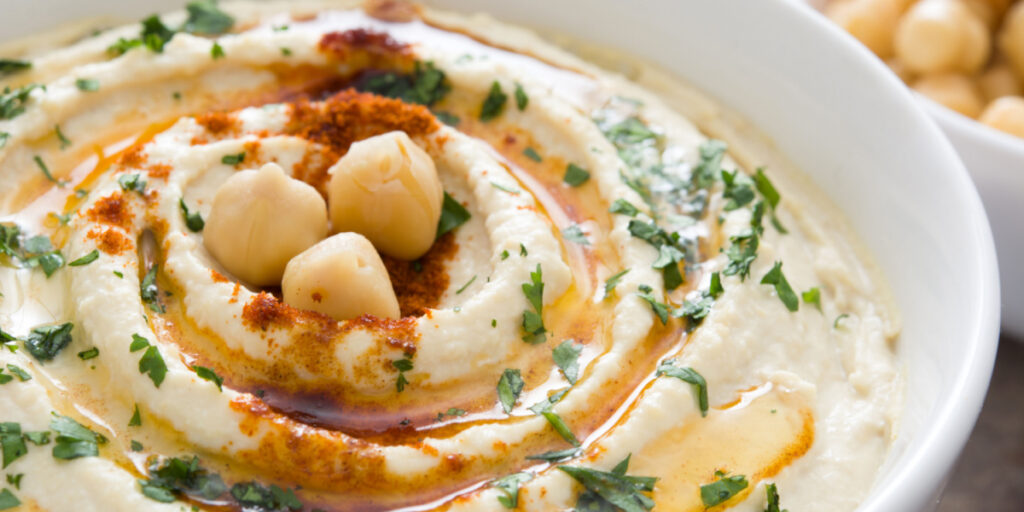 Hummus on a rustic wooden table