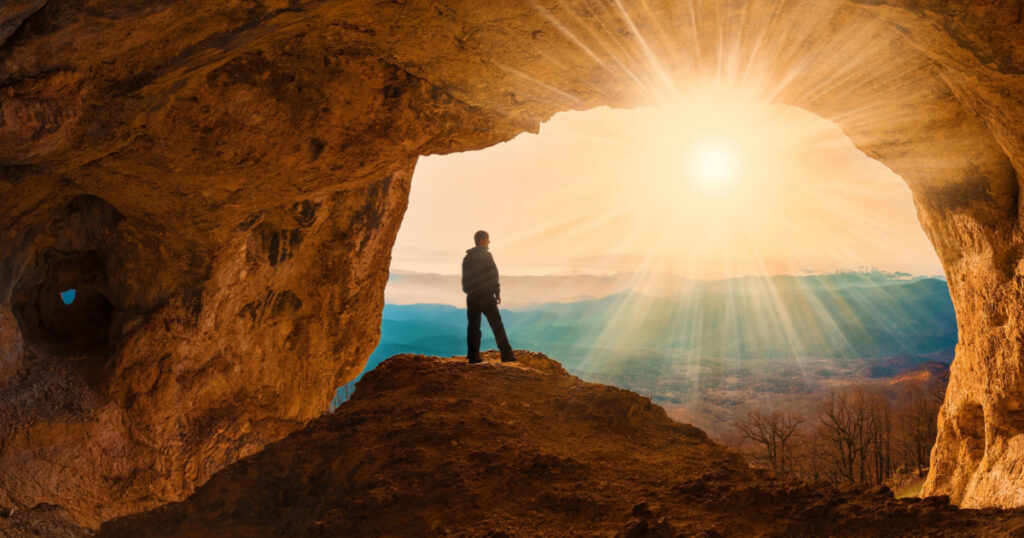 man in cave hiking