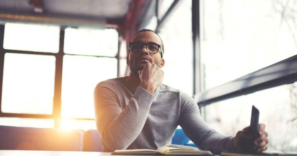 man working looking into distance thinking