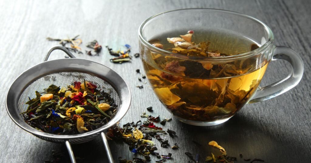 Brewed delicious herbal tea on a wooden black background