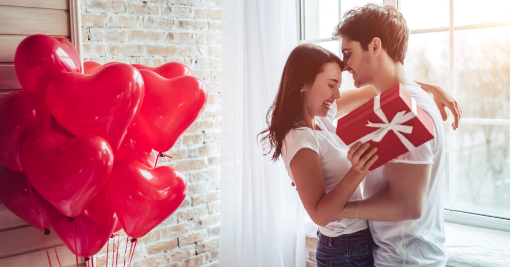 woman recieving gifts of love from man