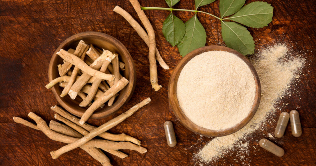 Ashwagandha superfood powder and root on cutting board on wooden table from above. Adaptogen.