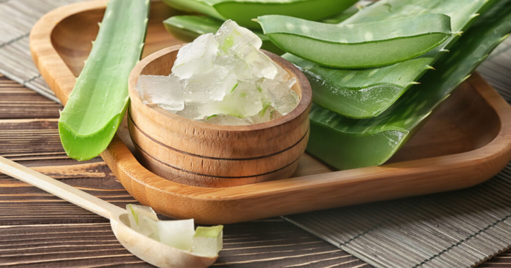Bowl with aloe vera on wooden tray