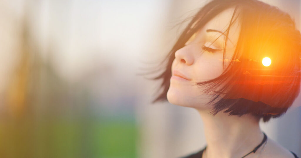 Double multiply exposure portrait of a dreamy cute woman meditating outdoors with eyes closed, combined with photograph of nature, sunrise or sunset, closeup. Psychology freedom power of mind concept
