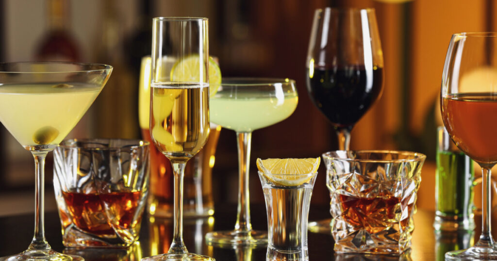 Different alcohol drinks on table in bar